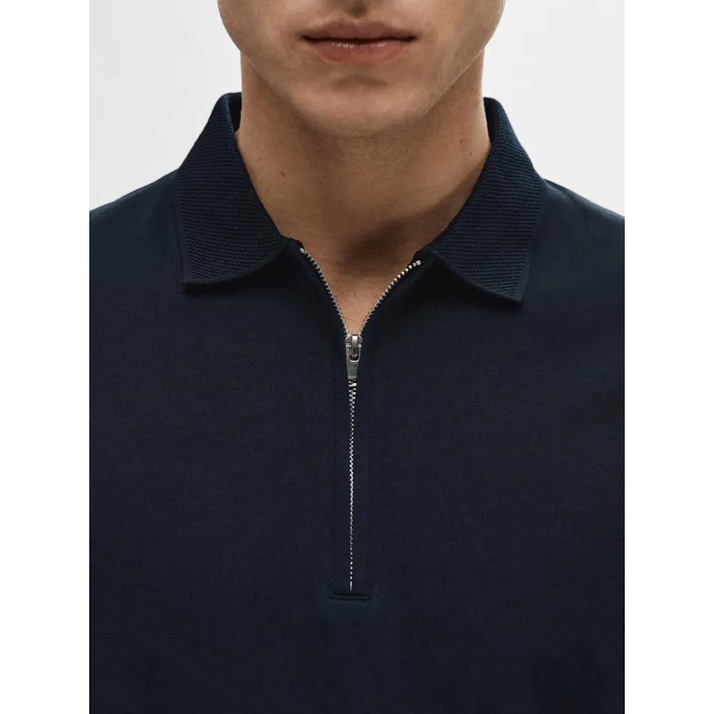 Polo shirt with half zip- Made of organic cotton and recycled polyester- Interlock fabric is a little thicker and smoother- Regular fit- Ribbed collar and cuffs- Mercerized for durability and a silk-like luster