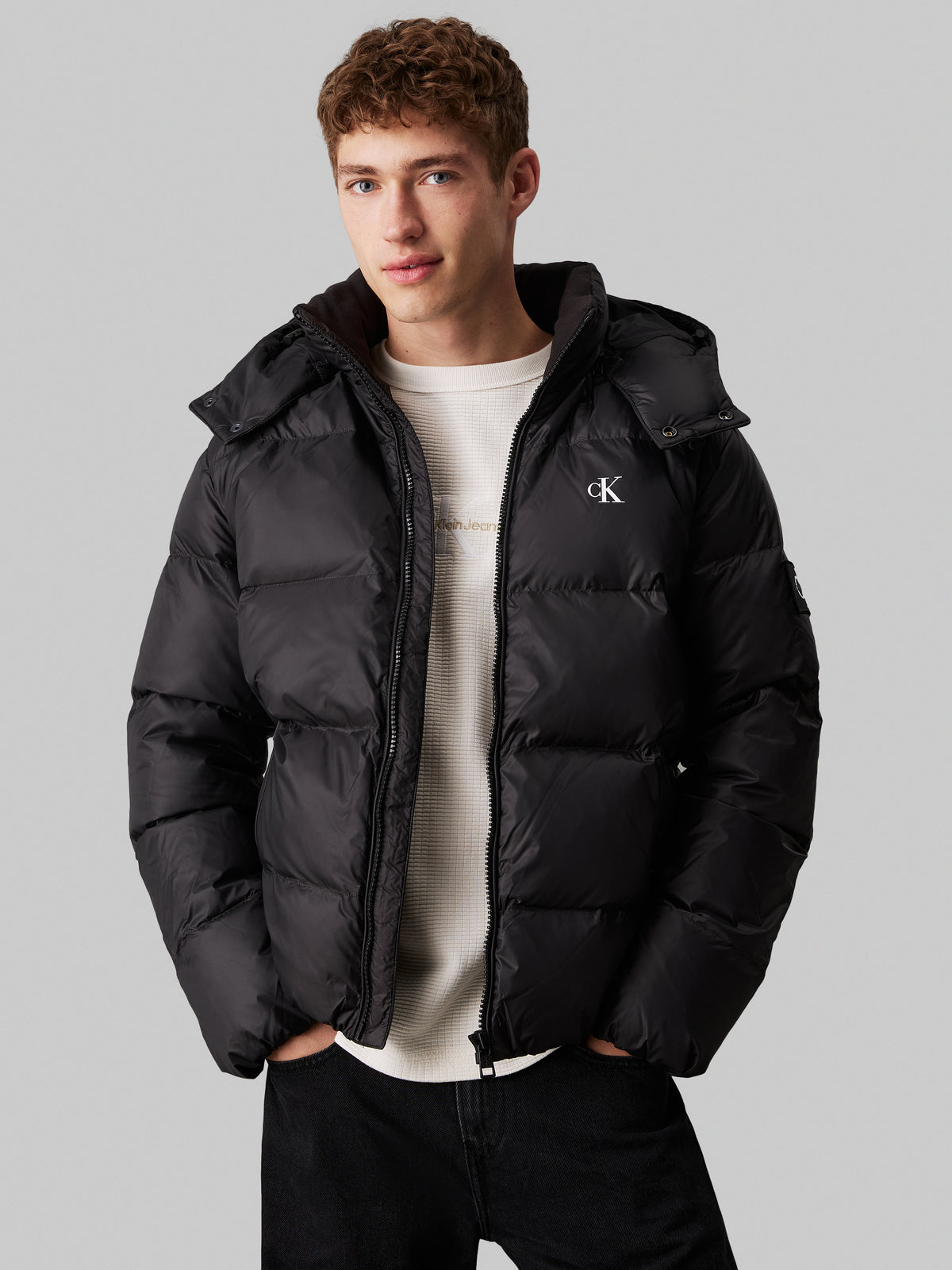 Calvin Klein Essential Down Jacket. Featuring lightweight down insulation and a sleek, minimalist design, this jacket is perfect for cold-weather comfort.