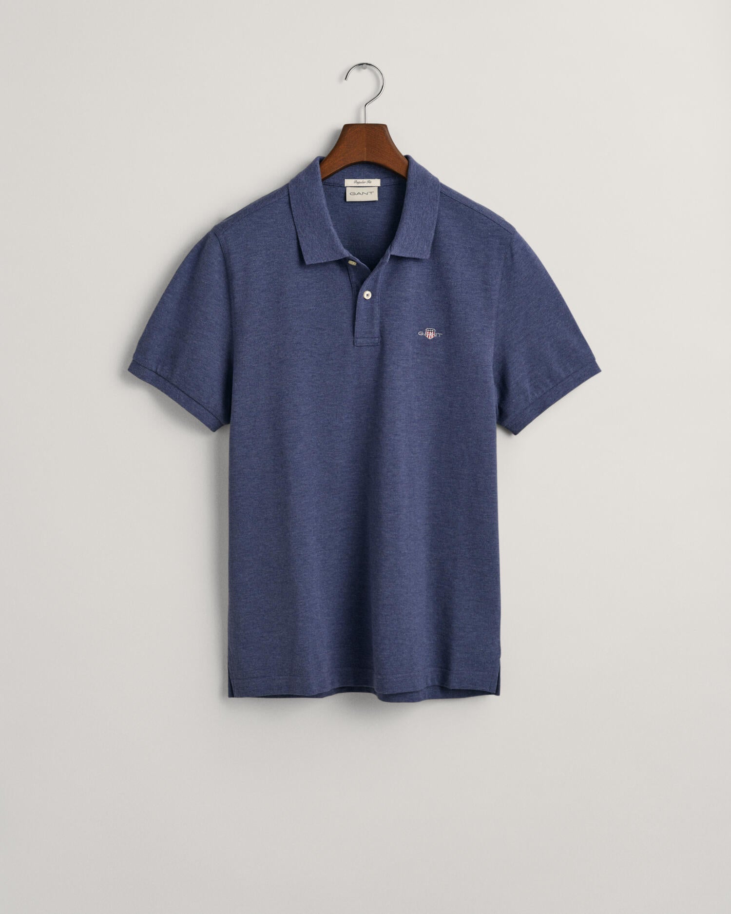 Our polo shirt keeps it easy, simple, and classic. With a regular fit and a traditional flat knit collar, details include a two-button placket, small side slits, and our signature GANT logo embroidered at the chest.