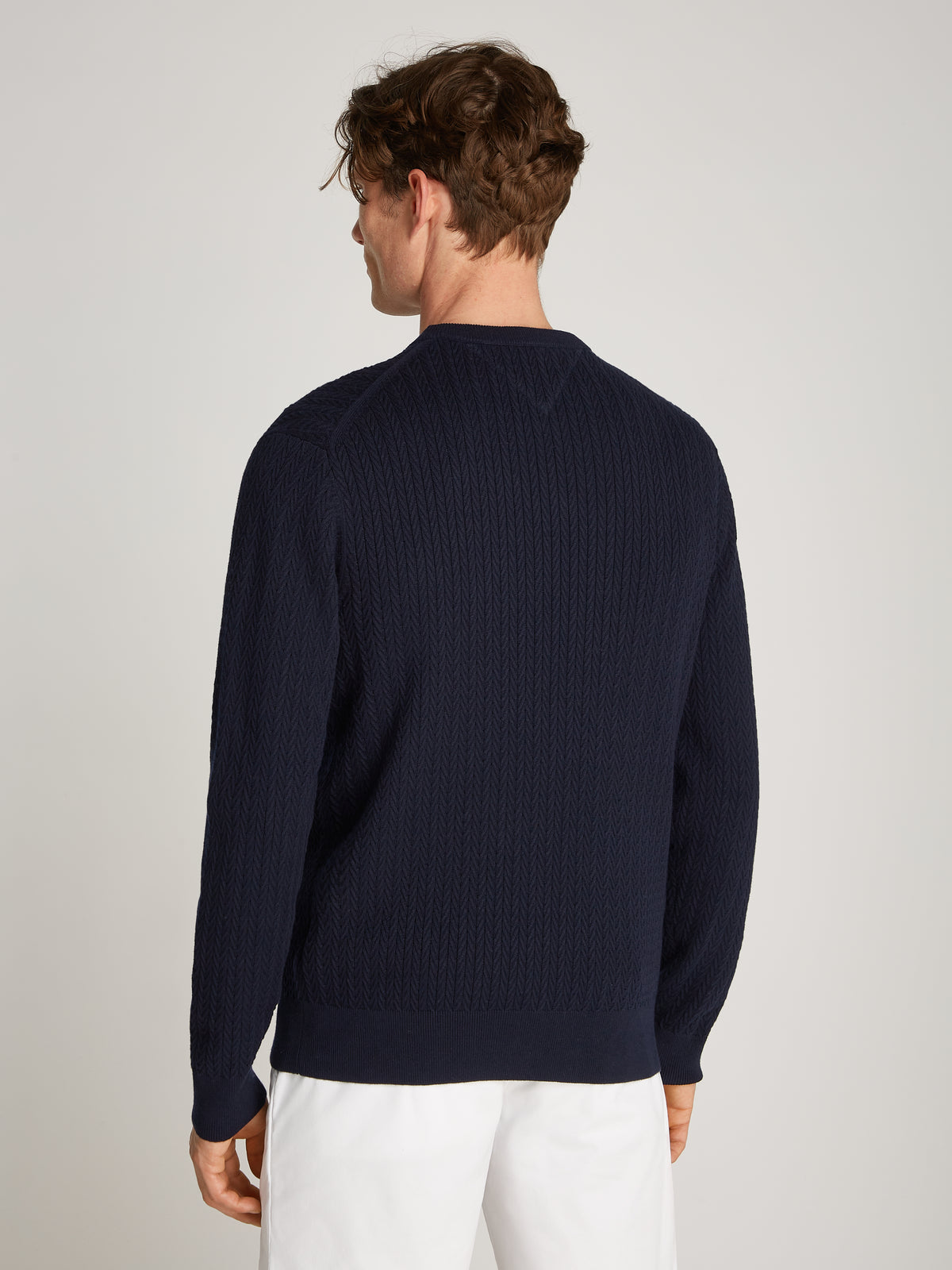 Tommy Hilfiger Herringbone Structure Crew Neck Jumper. Crafted from soft, premium fabric, this jumper features a sophisticated herringbone pattern that adds texture and depth to any casual or smart-casual outfit.