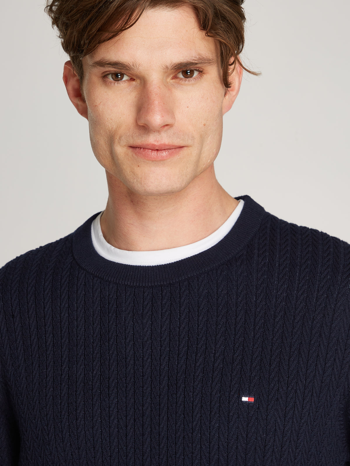 Tommy Hilfiger Herringbone Structure Crew Neck Jumper. Crafted from soft, premium fabric, this jumper features a sophisticated herringbone pattern that adds texture and depth to any casual or smart-casual outfit.