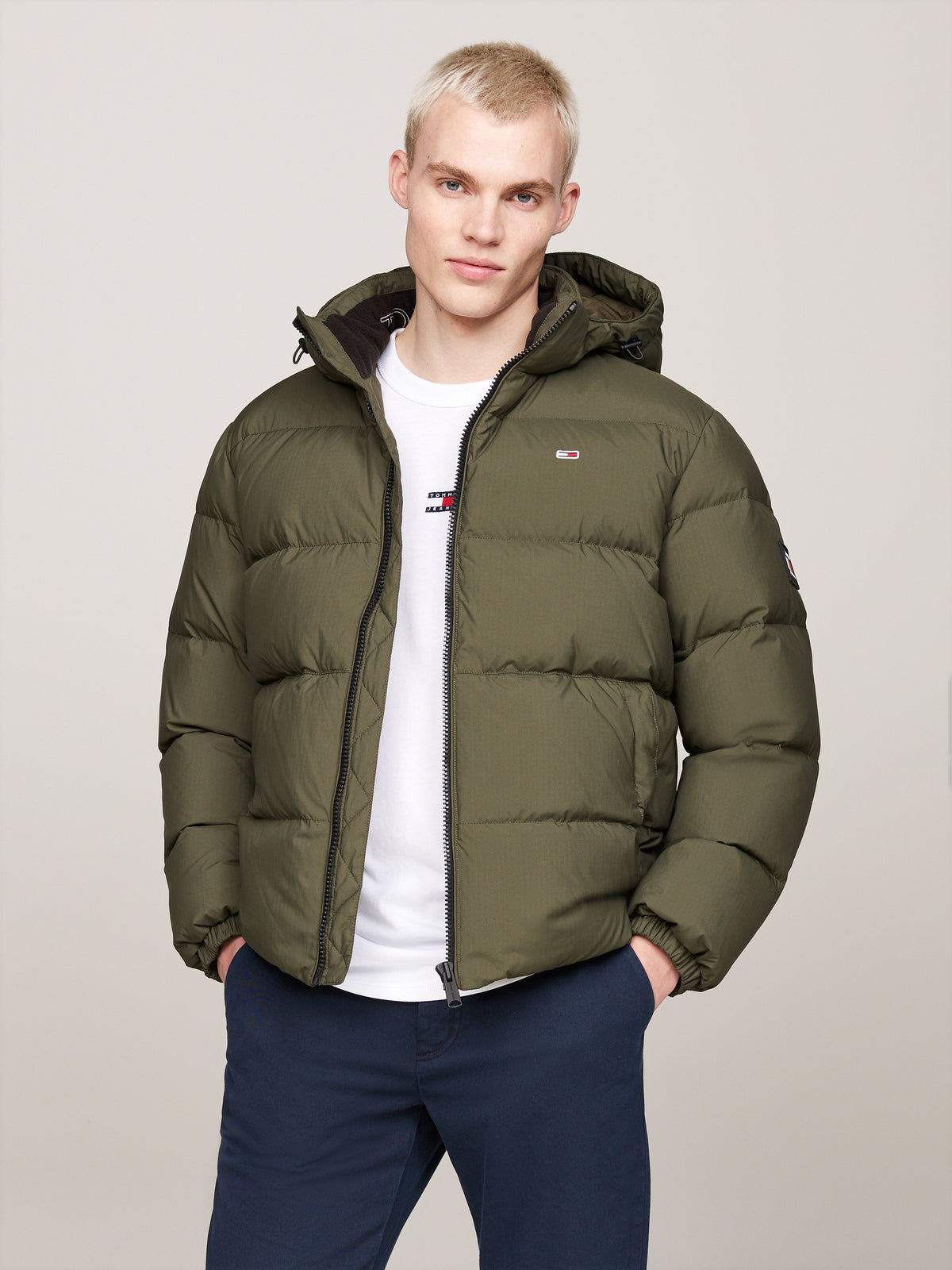 Tommy Jeans Essential Down Jacket. Featuring lightweight down insulation and a versatile design, this jacket is perfect for cold-weather comfort.